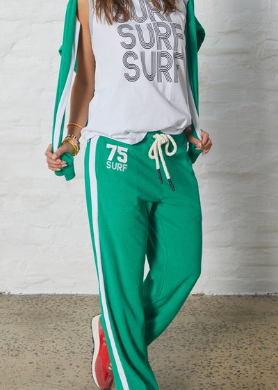 Hammill & Co lightweight terry towelling with white panelled stripes down each leg and white hip print. It has an elastic waistband with a chunky draw cord. The hem has a light overlocked stitch and comfy concealed side pockets.