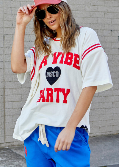 Hammill & Co tee with Rib panels on the sleeves and around the neck, peach cotton, La Vibe felt print on the front and small heart print on the back neck.