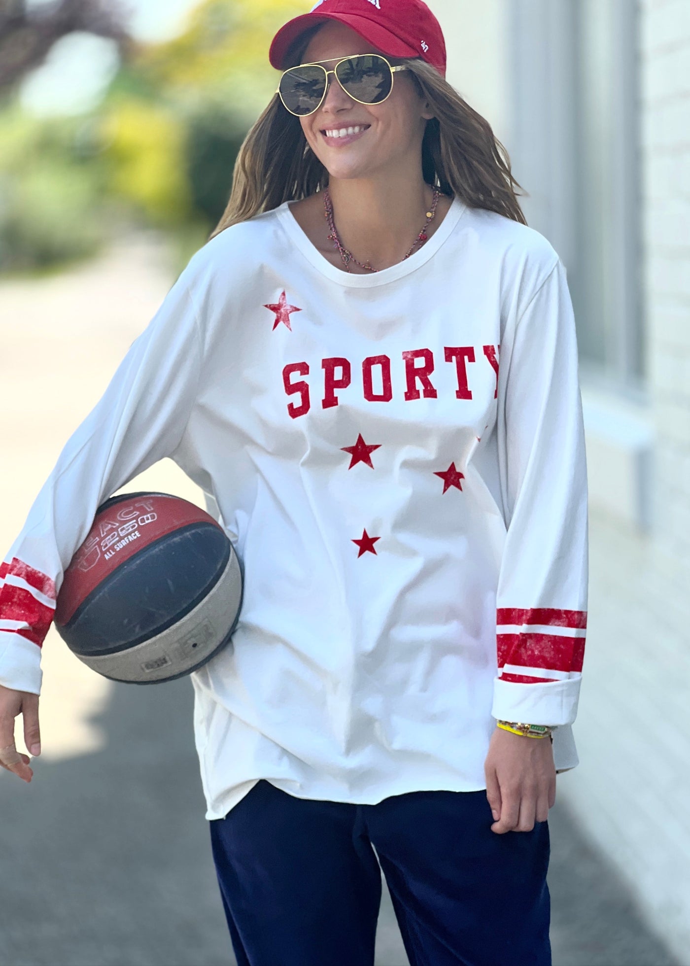 Hammill & Co oversized shape tee is here with raw hem.  Longer body and sleeves for a comfy look with leggings, distressed red sporty print on the front and stripes on each sleeve.