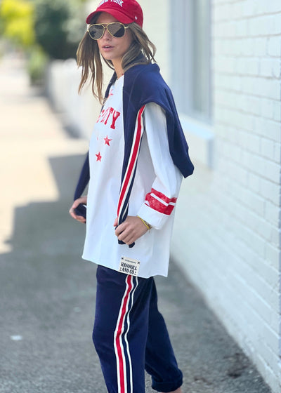 Hammill & Co oversized shape tee is here with raw hem.  Longer body and sleeves for a comfy look with leggings, distressed red sporty print on the front and stripes on each sleeve.