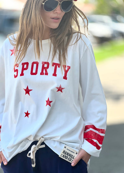 Hammill & Co oversized shape tee is here with raw hem.  Longer body and sleeves for a comfy look with leggings, distressed red sporty print on the front and stripes on each sleeve.