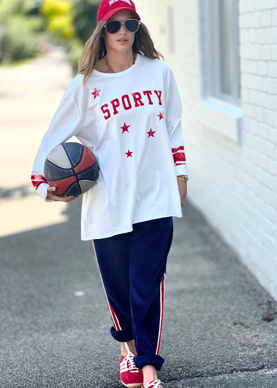 Hammill & Co oversized shape tee is here with raw hem.  Longer body and sleeves for a comfy look with leggings, distressed red sporty print on the front and stripes on each sleeve.