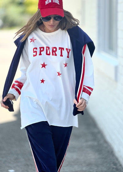 Hammill & Co oversized shape tee is here with raw hem.  Longer body and sleeves for a comfy look with leggings, distressed red sporty print on the front and stripes on each sleeve.