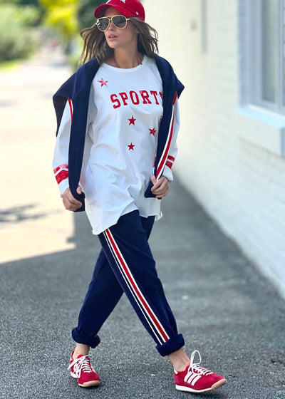 Hammill & Co oversized shape tee is here with raw hem.  Longer body and sleeves for a comfy look with leggings, distressed red sporty print on the front and stripes on each sleeve.