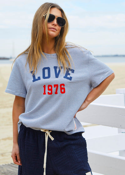 Hammill & Co tee is a total throwback in the best way. With fine navy and white stripes and a pop of red“1976 LOVE” across the front.