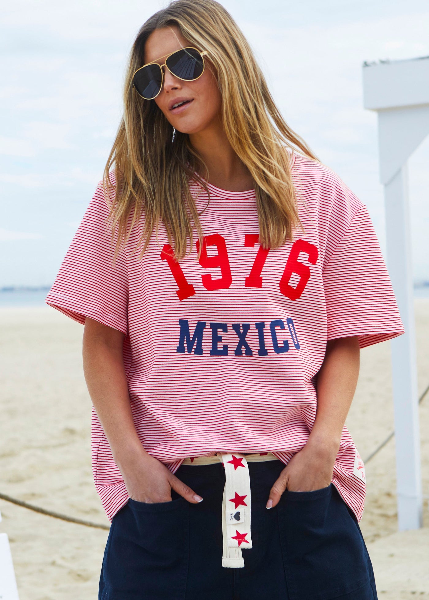 Hammill & Co tee is a total throwback in the best way. With fine red and white stripes and a pop of red and navy “1976 MEXICO” across the front.