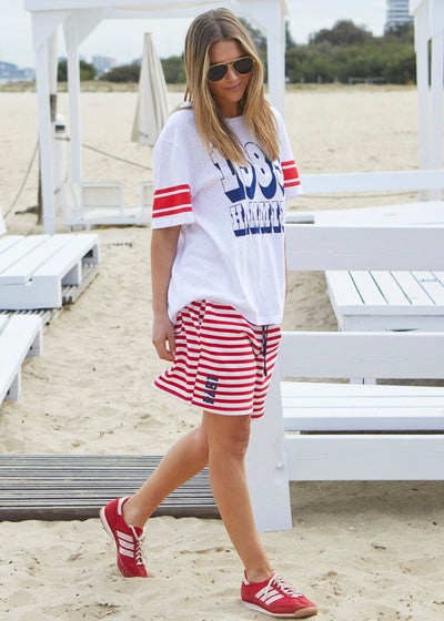 Hammill & Co White slouchy tee with navy 1985 print on the front and red stripes on each sleeve. Our standard over size fit, the same as our logo tees.