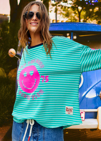 Hammill & Co Green and white stripe rib waffle long sleeve tee with navy contrast rib and pink Smily print on the front and keep smiling down the left sleeve. 