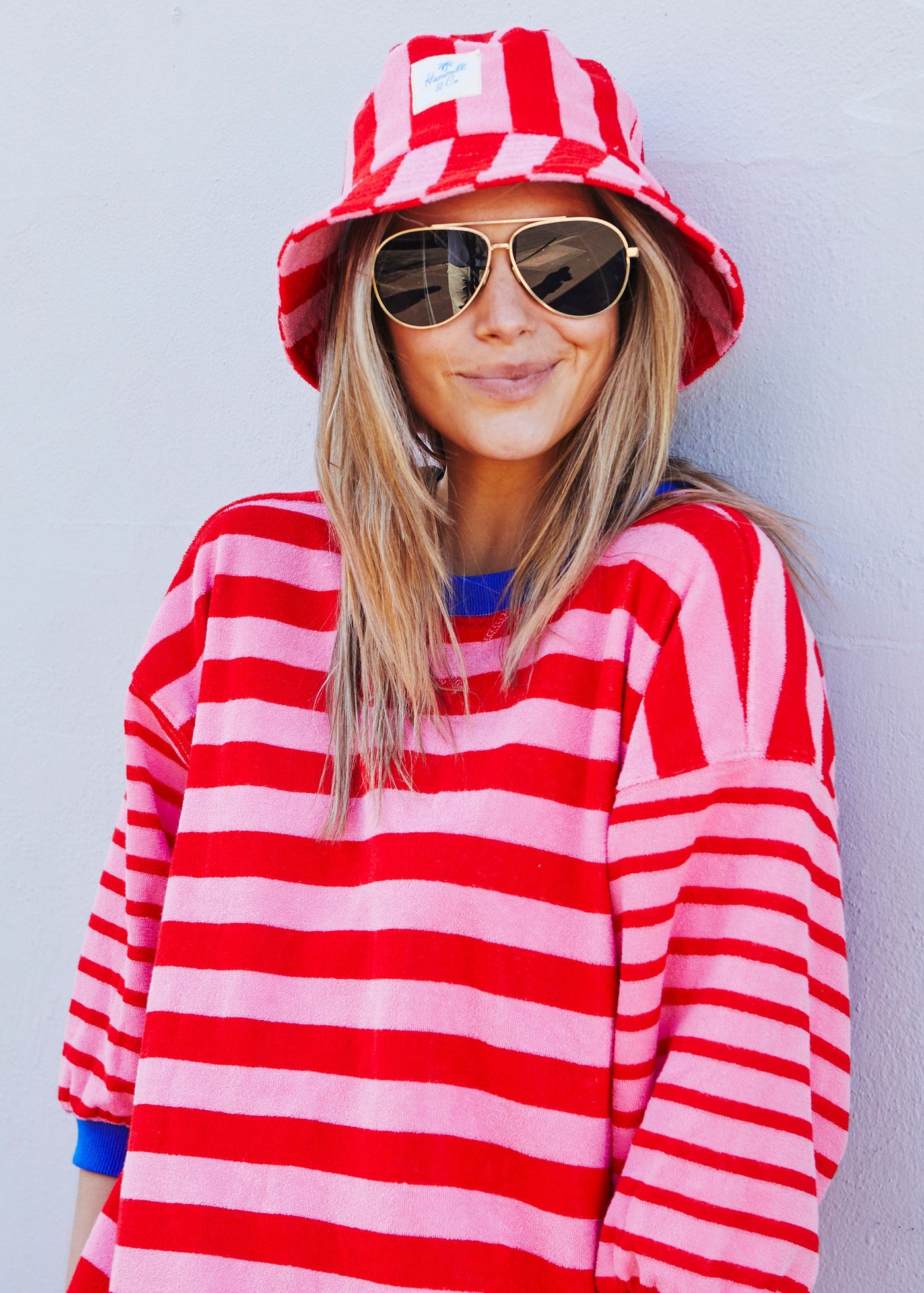 Hammill & Co bold striped bucket hat is pure summer happiness. Made from soft terry towelling in vibrant red and pink stripes
