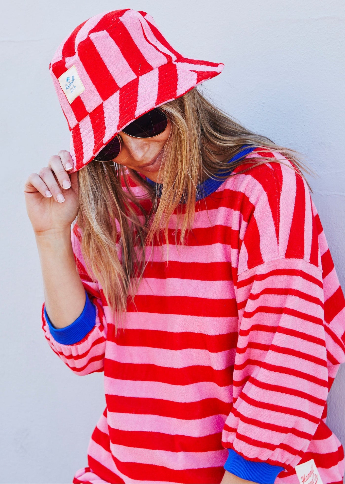 Hammill & Co bold striped bucket hat is pure summer happiness. Made from soft terry towelling in vibrant red and pink stripes