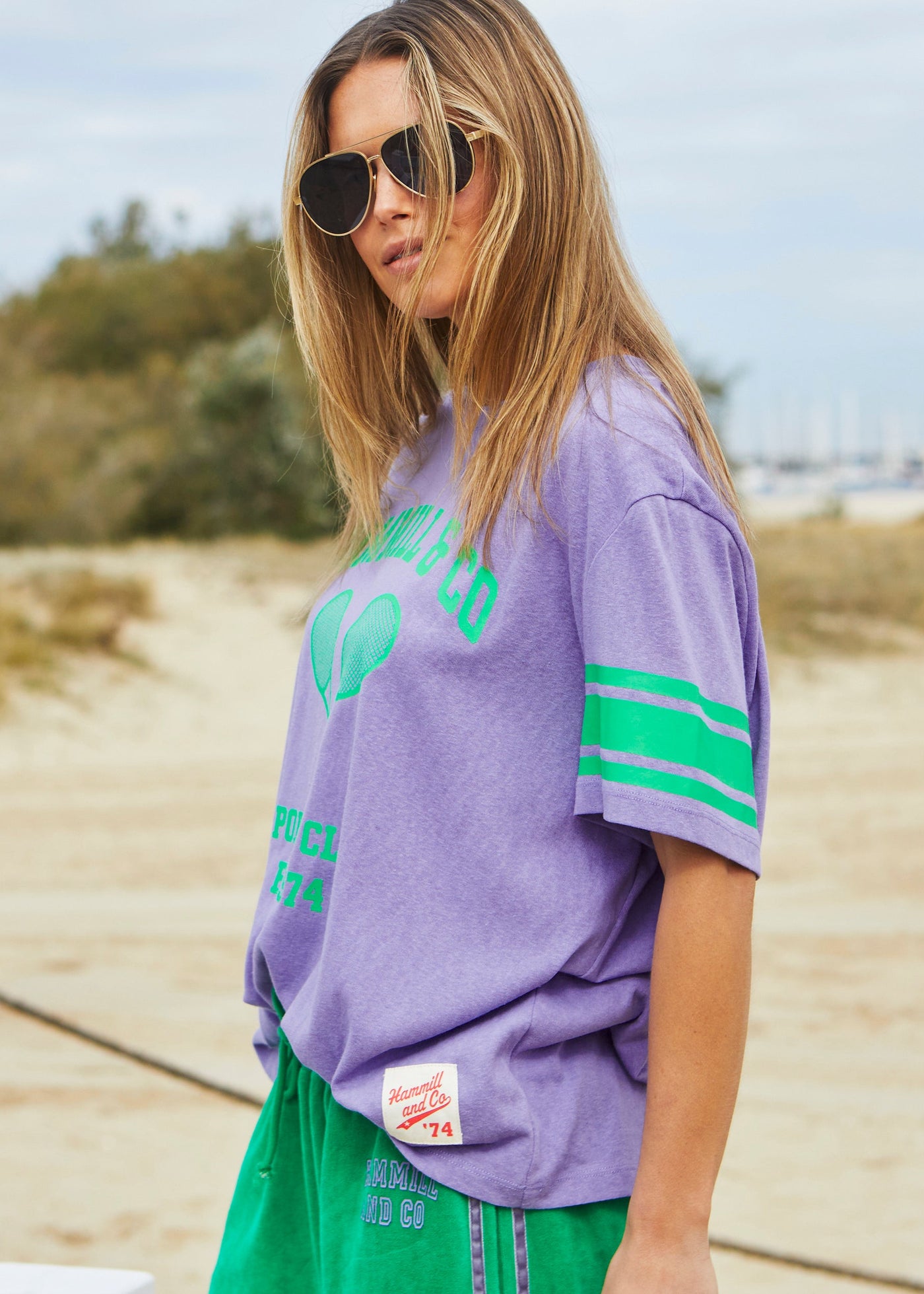 Hammill & Co Slouchy crew neck tee in a soft mauve slub jersey with green retro Tennis print on the front and stripes on each sleeve. Looks great worn back with the velour pants and shorts!